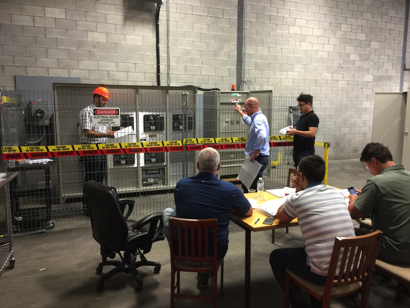 Team reviewing the electrical equipment